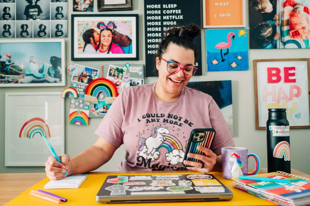 Colie James sits at desk and talks on phone about how to build a high-end client experience.